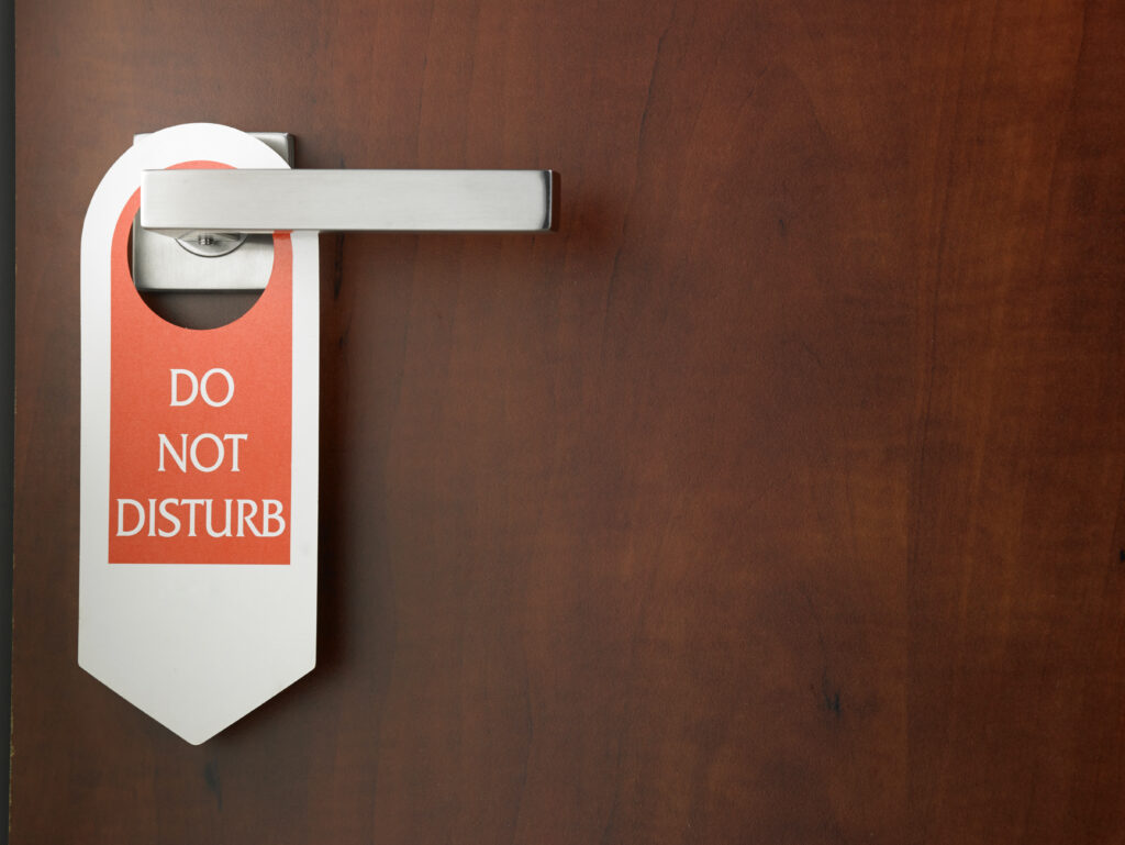 Do,Not,Disturb,Door,Sign,Hanging,At,Door,Handle