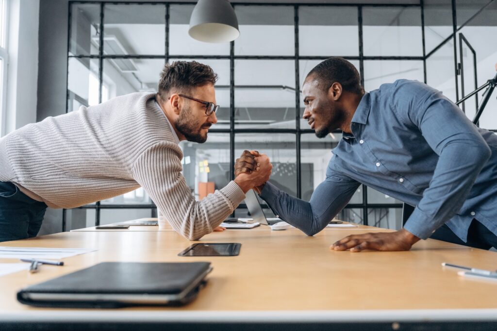 Two,Office,Workers,Are,Having,Fun,And,Doing,Arm,Wrestling.